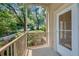 Balcony with metal railing overlooking lush greenery and street at 2865 Lenox Ne Rd # 103, Atlanta, GA 30324