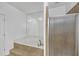 Bathroom featuring a luxurious jacuzzi tub and glass-enclosed shower at 2865 Lenox Ne Rd # 103, Atlanta, GA 30324