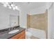 Bathroom features a granite vanity, tile surround, and tub at 2865 Lenox Ne Rd # 103, Atlanta, GA 30324