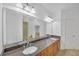 Bathroom featuring dual sinks, granite countertops, and a large mirror at 2865 Lenox Ne Rd # 103, Atlanta, GA 30324