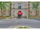 Elegant building entrance features a red awning and manicured landscaping for an inviting feel at 2865 Lenox Ne Rd # 103, Atlanta, GA 30324
