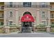 Elegant building entrance features a red awning and well-manicured landscaping for a welcoming feel at 2865 Lenox Ne Rd # 103, Atlanta, GA 30324