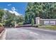 Community entrance with lush plants and 'Le Chateau' sign at 2865 Lenox Ne Rd # 103, Atlanta, GA 30324