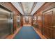 Beautiful hallway with elevators, chandelier, wood paneled walls and lovely carpet at 2865 Lenox Ne Rd # 103, Atlanta, GA 30324