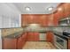 Kitchen boasting wood cabinets, granite counters, tile backsplash, and stainless steel appliances at 2865 Lenox Ne Rd # 103, Atlanta, GA 30324