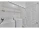 Laundry room with white washer, dryer, shelving, and door at 2865 Lenox Ne Rd # 103, Atlanta, GA 30324