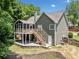 Exterior of home with a screened in porch and stairs leading to a stone patio at 3372 English Oaks Nw Dr, Kennesaw, GA 30144