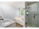 Bathroom with double vanity, soaking tub, and glass-enclosed shower at 3372 English Oaks Nw Dr, Kennesaw, GA 30144