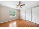 Cozy bedroom with hardwood floors, neutral walls, and a double door closet at 3372 English Oaks Nw Dr, Kennesaw, GA 30144