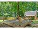 Wooden deck with stairs and black pillars with two chairs facing towards the backyard at 3372 English Oaks Nw Dr, Kennesaw, GA 30144