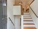 Bright foyer with wood staircase and banister leading to the upper level at 3372 English Oaks Nw Dr, Kennesaw, GA 30144