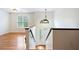 Upper level view of home's entryway with hardwood flooring and a white-framed door at 3372 English Oaks Nw Dr, Kennesaw, GA 30144