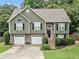 Charming two-story home with a stone-accented facade, a well-manicured lawn, and a two-car garage at 3372 English Oaks Nw Dr, Kennesaw, GA 30144