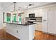 Bright kitchen featuring an island with a countertop and modern appliances at 3372 English Oaks Nw Dr, Kennesaw, GA 30144