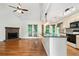 Open living area featuring a stone fireplace, hardwood floors, and a kitchen island at 3372 English Oaks Nw Dr, Kennesaw, GA 30144
