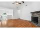 Bright open-plan living area with hardwood floors and a stone fireplace at 3372 English Oaks Nw Dr, Kennesaw, GA 30144