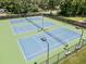 Community tennis courts offering well-maintained playing surfaces and lighting for evening games at 3372 English Oaks Nw Dr, Kennesaw, GA 30144