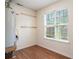 Functional utility room with water heater and large window providing natural light at 3372 English Oaks Nw Dr, Kennesaw, GA 30144