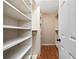Well-organized walk-in closet with built-in shelving and hardwood floors at 3372 English Oaks Nw Dr, Kennesaw, GA 30144