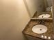 Bathroom featuring a double vanity with granite countertops and modern fixtures at 5040 Brittany Dr, Stone Mountain, GA 30083