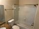 Bathroom featuring a shower-tub combo, granite sink countertop, and standard fixtures at 5040 Brittany Dr, Stone Mountain, GA 30083