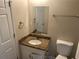 Bathroom with a large mirror, granite countertop, and white cabinet at 5040 Brittany Dr, Stone Mountain, GA 30083