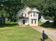 Two-story home with a well-maintained lawn and a driveway at 5040 Brittany Dr, Stone Mountain, GA 30083