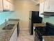 Functional kitchen with stainless steel appliances, granite countertops, and ample cabinet space at 5040 Brittany Dr, Stone Mountain, GA 30083