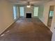 Spacious living room with carpet, bright windows, a ceiling fan, and a cozy fireplace at 5040 Brittany Dr, Stone Mountain, GA 30083