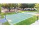 Outdoor basketball court surrounded by lush greenery, providing a space for sports and recreation at 5059 Winding Hills Lane Ln, Woodstock, GA 30189
