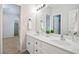 Bright bathroom featuring a double sink vanity, large mirror, and neutral color scheme at 5059 Winding Hills Lane Ln, Woodstock, GA 30189