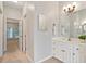 Clean bathroom with a white vanity, ample lighting, and easy access to other rooms at 5059 Winding Hills Lane Ln, Woodstock, GA 30189