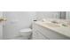 Cozy bathroom featuring a white vanity, sink, toilet and chrome fixtures at 5059 Winding Hills Lane Ln, Woodstock, GA 30189