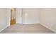 Cozy bedroom with soft carpet flooring, neutral-toned walls, and an open door leading to the hallway at 5059 Winding Hills Lane Ln, Woodstock, GA 30189