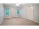 Well-lit bedroom featuring two windows, plush carpet, and a closet at 5059 Winding Hills Lane Ln, Woodstock, GA 30189
