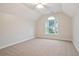 Bright bedroom with neutral carpet, a ceiling fan and a large arched window at 5059 Winding Hills Lane Ln, Woodstock, GA 30189