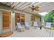 Relax on this outdoor deck, complete with stylish seating, ceiling fan and convenient access to the backyard at 5059 Winding Hills Lane Ln, Woodstock, GA 30189