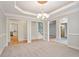Open-concept dining room with a modern chandelier, neutral colors, and views to other rooms at 5059 Winding Hills Lane Ln, Woodstock, GA 30189