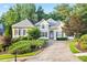Beautiful two-story home with an inviting driveway and lush landscaping surrounding the property at 5059 Winding Hills Lane Ln, Woodstock, GA 30189