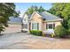 Charming home featuring a neutral facade, well-maintained landscaping, and an attached two-car garage at 5059 Winding Hills Lane Ln, Woodstock, GA 30189