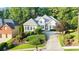 Manicured lawn and mature trees surround this beautiful two-story home with a neutral color scheme at 5059 Winding Hills Lane Ln, Woodstock, GA 30189