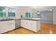 Modern kitchen features a breakfast bar, white cabinets, stainless appliances, and hardwood floors at 5059 Winding Hills Lane Ln, Woodstock, GA 30189