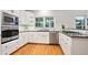 Updated kitchen with stainless appliances, granite countertops, and white cabinetry at 5059 Winding Hills Lane Ln, Woodstock, GA 30189