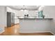 Kitchen showcasing stainless steel appliances, white cabinets, and a breakfast bar at 5059 Winding Hills Lane Ln, Woodstock, GA 30189