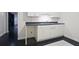 A convenient kitchenette featuring white cabinets and a sink perfect for snacks at 5059 Winding Hills Lane Ln, Woodstock, GA 30189