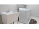Well-equipped laundry room with a utility sink and a modern washer and dryer set at 5059 Winding Hills Lane Ln, Woodstock, GA 30189