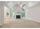 Spacious living room featuring a vaulted ceiling, a fireplace, and abundant natural light at 5059 Winding Hills Lane Ln, Woodstock, GA 30189