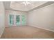 A spacious main bedroom featuring a tray ceiling, plush carpeting, and abundant natural light at 5059 Winding Hills Lane Ln, Woodstock, GA 30189