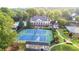 A view of the community clubhouse and tennis courts with players enjoying a match at 5059 Winding Hills Lane Ln, Woodstock, GA 30189