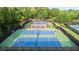 This showcases the well-maintained tennis courts with a gazebo in a lush, landscaped setting at 5059 Winding Hills Lane Ln, Woodstock, GA 30189